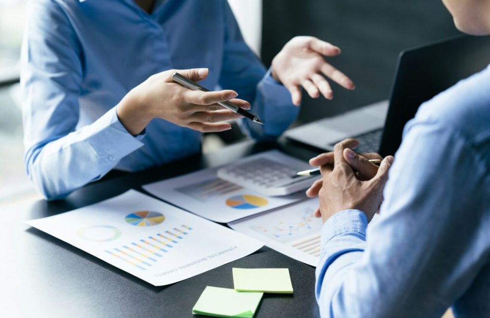 business-team-reviewing-a-diagram-or-chart-and-financial-reports-e1715621277367